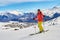 Woman skier posing on the ski slopes above La Toussuire village in France, Les Sybelles ski domain, on a perfect sunny day