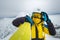 woman skier posing on the top of snowed mountain