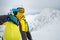 woman skier posing on the top of snowed mountain