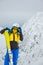 woman skier posing on the top of snowed mountain