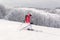 Woman skier running downhill on snow piste