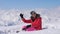 Woman Skier Shows Hand Ok And Finger Up On The Snowy Mountains Background