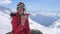 Woman Skier Sits On A Stone In The Mountains Ski Resort And Eats A Sandwich