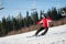 Woman skier with ski at winer resort in sunny day