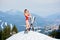 woman skier with skis on snowy slope at winter ski resort