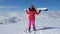 Woman Skier Standing On The Slope Mountain, Holding Hands The Ski On Shoulders