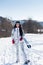 Woman Skier Standing at Snow Looking at Camera