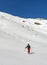 A woman skiing an off-piste slope in fresh powder in the mountains. Ski touring