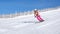 Woman skiing at Sinaia resort in Romania on a sunny day with perfect snow, on a medium difficulty slope red piste.