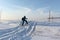 Woman skiing on the trail of a snowmobile on a snowy island Hrenoviy, Ob Reservoir, Novosibirsk, Russia