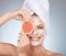 Woman, skincare and mask with grapefruit, smile or happy in studio for wellness, self care or beauty. Model, skin and