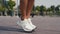 woman skipping rope exercising outdoor at sunny day. Close-up of young women foot