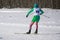 Woman skis on slope in winter day at sports complex