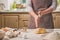 Woman slap his hands above dough closeup. Baker finishing his bakery, shake flour from his hands, free space for text.