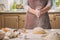 Woman slap his hands above dough closeup. Baker finishing his bakery, shake flour from his hands, free space for text.