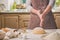 Woman slap his hands above dough closeup. Baker finishing his bakery, shake flour from his hands, free space for text.