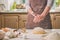 Woman slap his hands above dough closeup. Baker finishing his bakery, shake flour from his hands, free space for text.