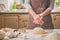 Woman slap his hands above dough closeup. Baker finishing his bakery, shake flour from his hands, free space for text.