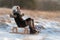 Woman sledging down hill, bright and joyful winter scene