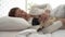 woman sleep with dog pug breed on bed in bedroom