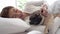 woman sleep with dog pug breed on bed in bedroom