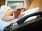 Woman sleeping in bed being woken by phone, focus on hand.