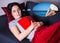 woman sleeping with book on sofa at home and dreaming about travel