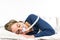 Woman sleeping on her side with CPAP, sleep apnea treatment.