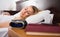 Woman sleeping near clock and book