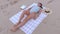 Woman sleeping on the towel in beach