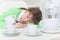 Woman sleeps on table among coffee cups