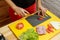 Woman slice tomato. Cooking from fresh vegetables