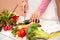 Woman slicing cucumber on chopping board