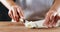 Woman slicing dough on chopping board 4k