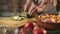 Woman slicing fresh healthy vegetables in the kitchen