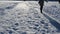 Woman slide frozen ice field lake winter evening sulight shadows