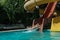 Woman slides down from the slide into the pool