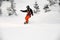 Woman slides down a snow covered steep slope