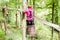 Woman sliding in barrel at high rope climbing course