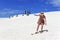 Woman sliding down with a snowboard on Lancelin sand dunes