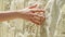 Woman sliding hand against old stone wall in slow motion. Female hand touching rough surface of rock