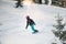 Woman sliding from mountain on a professional snowboard