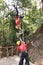 Woman sliding on a zip line in an adventure park