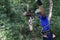 Woman sliding on a zip line in an adventure park