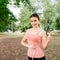 Woman with slim body measuring her waistline