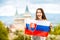 Woman with slovak flag near the castle