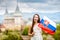 Woman with slovak flag near the castle