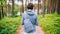 Woman with a small backpack on a walk in the forest