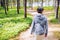 Woman with a small backpack on a walk in the forest