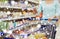 Woman with smartphone buying food at supermarket